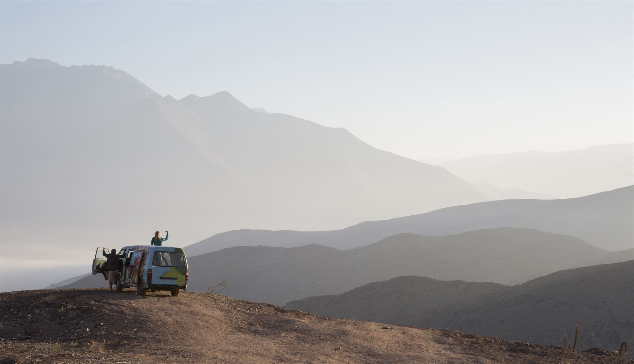 Couple enjoying sunset on safari jeep