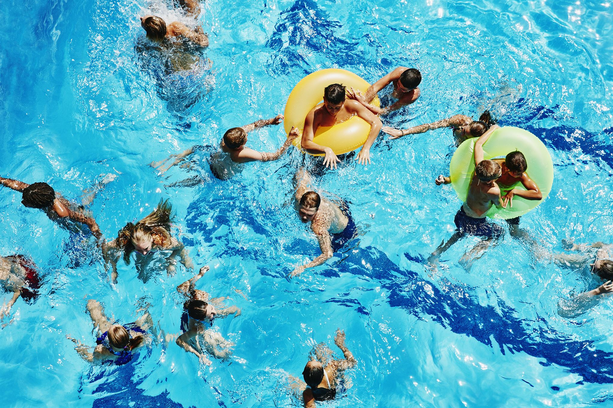 Children swimming in pool during practice