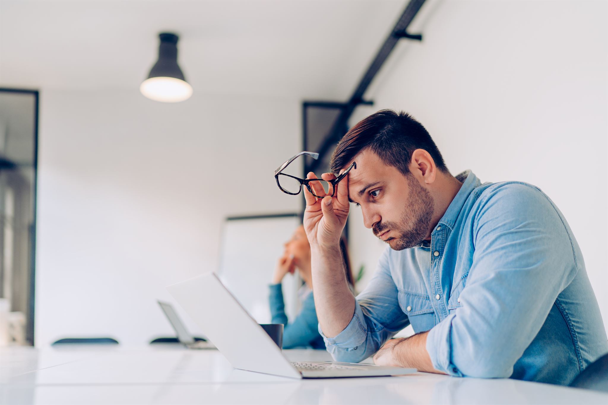 Employee accessing FAQ on laptop