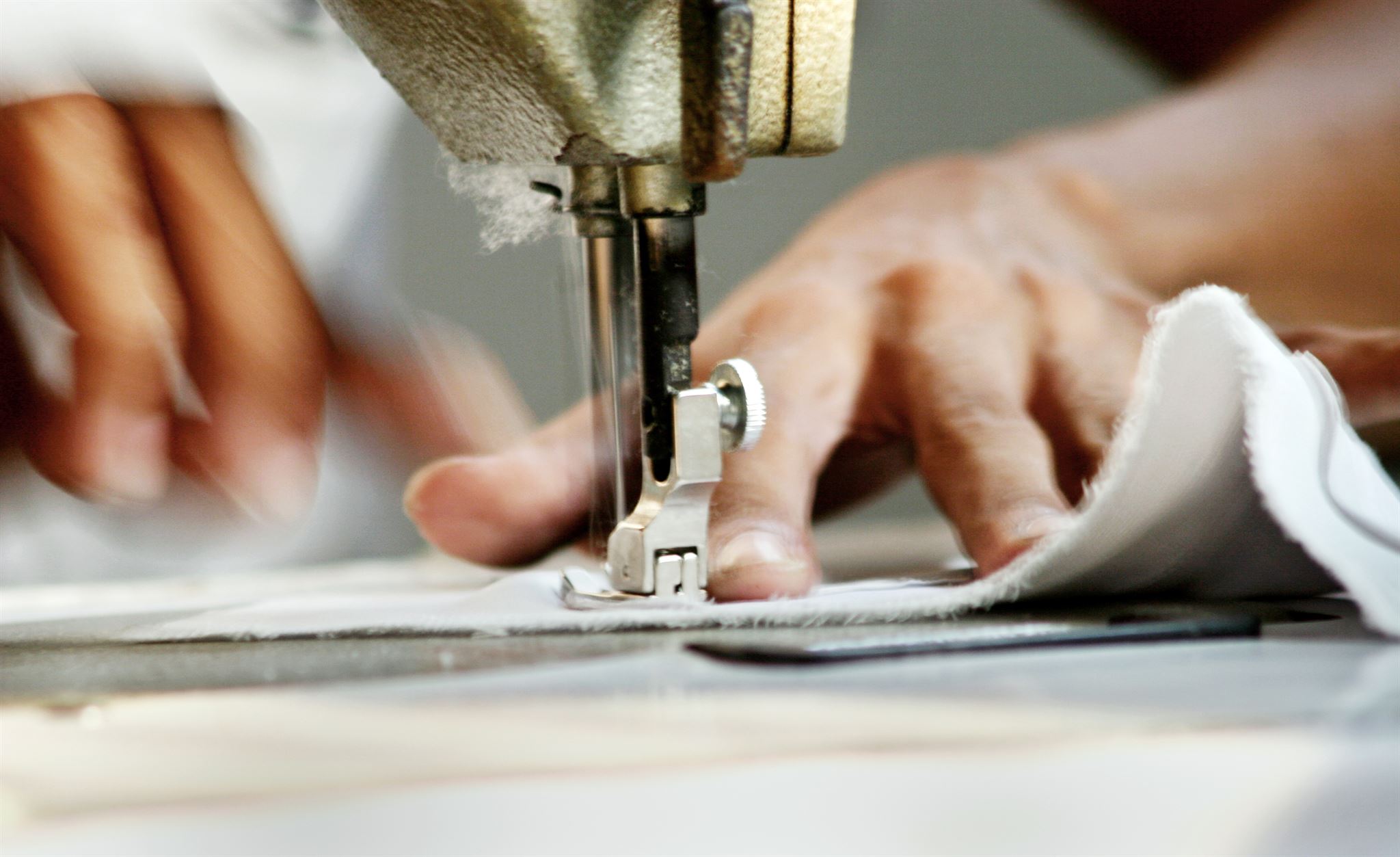 Garment factory workers operating sewing machines