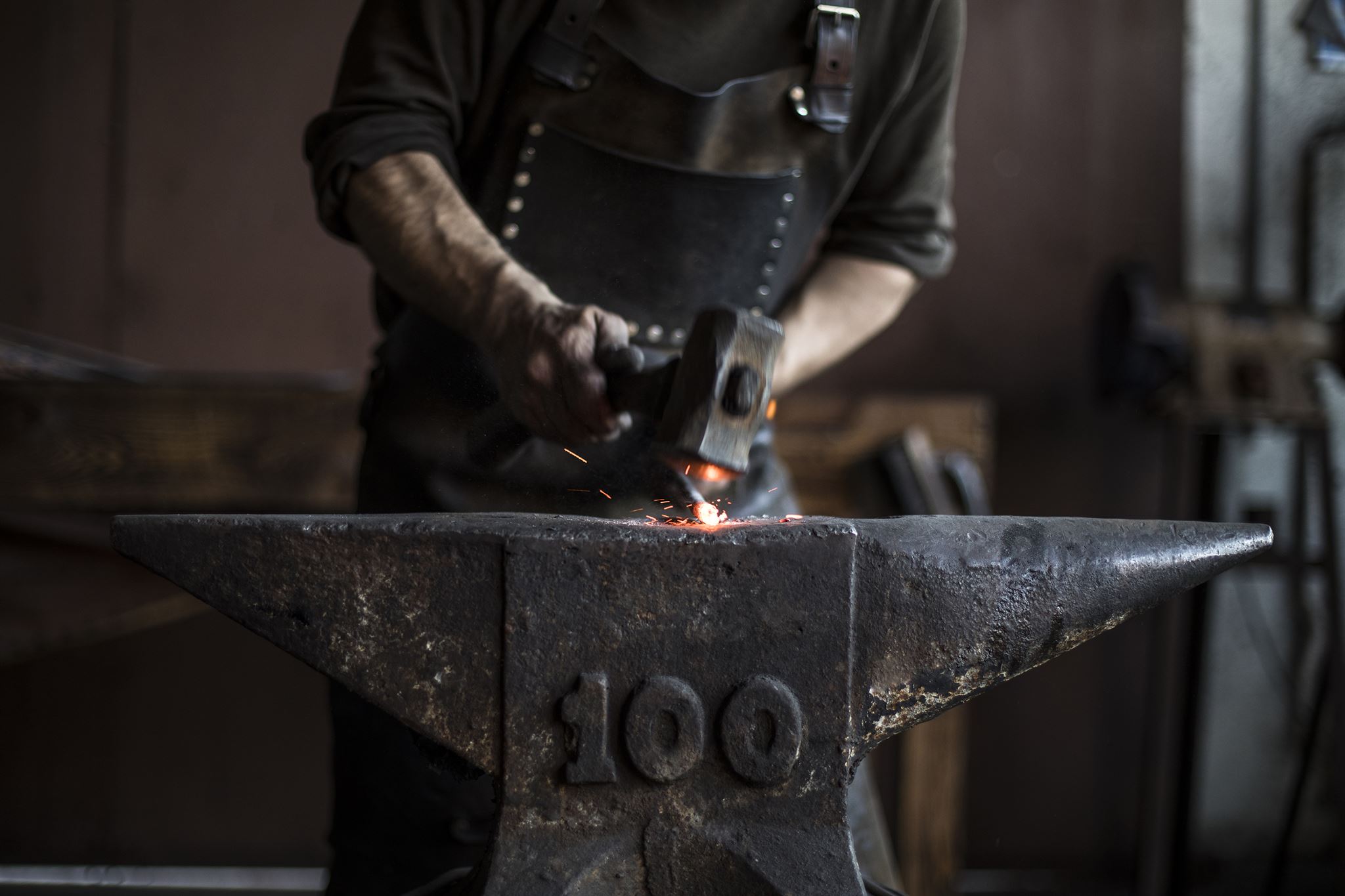 Glowing forge with anvils