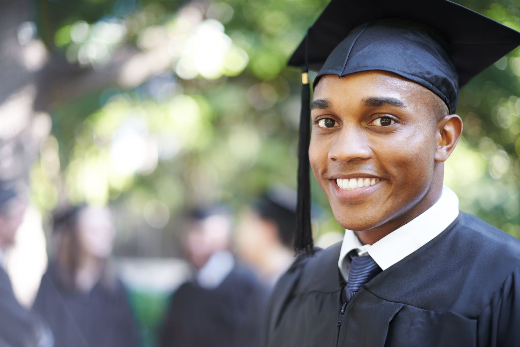 Graduate smiling with gray background