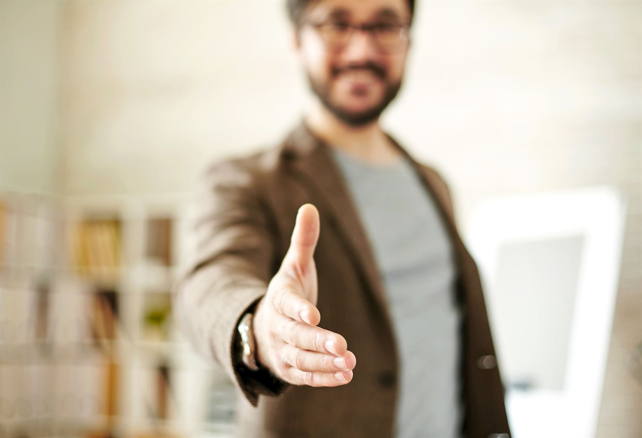 Happy client shaking hands with financial advisor