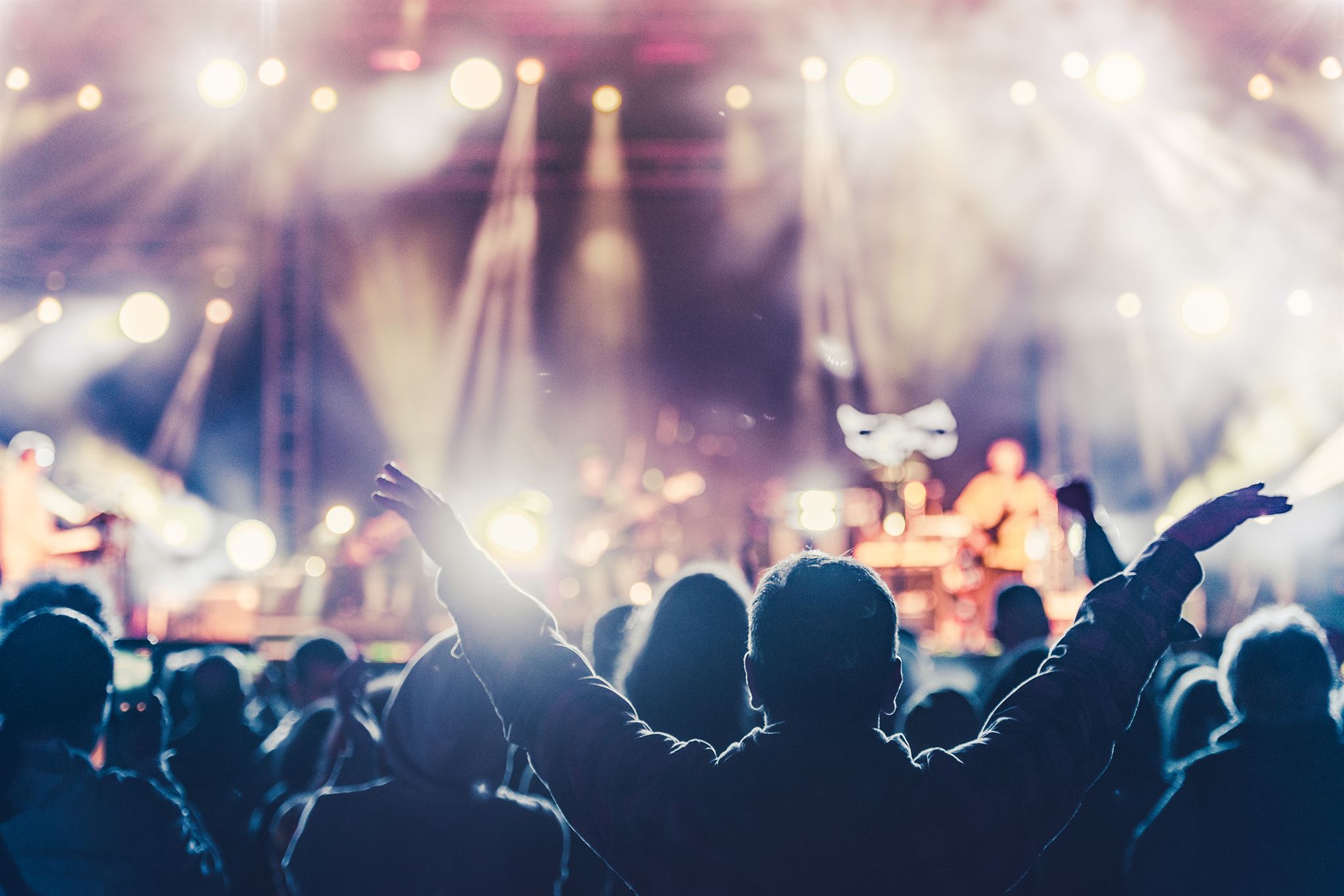 Rock band crowd surfing at concert