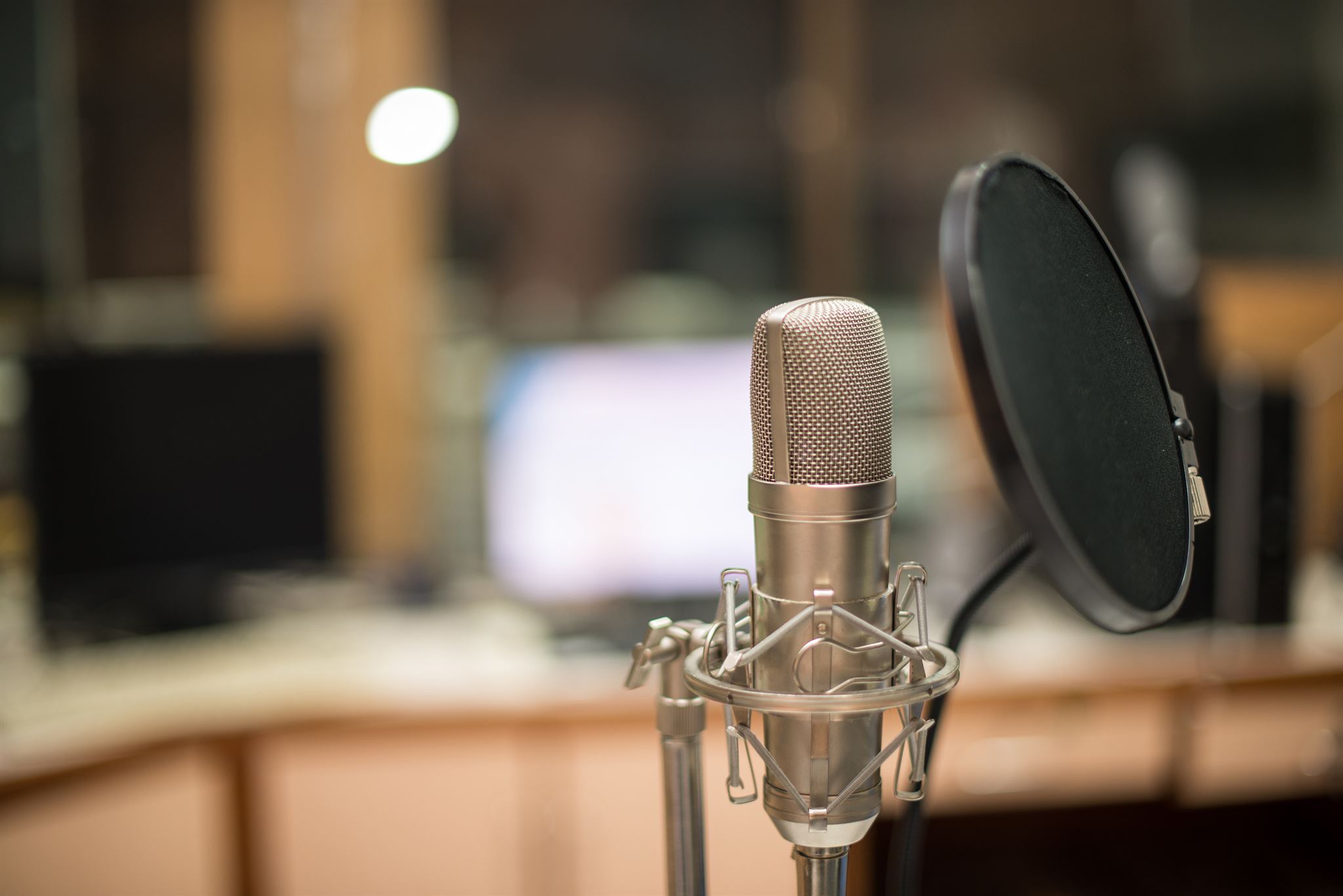 Newspaper and microphone on a wooden table