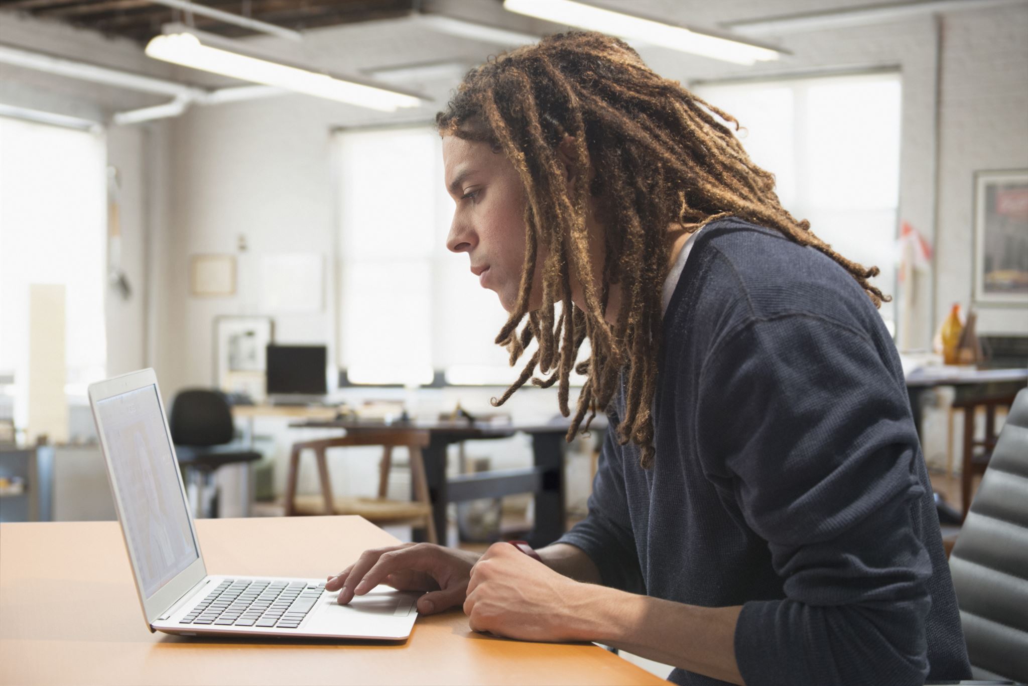 Student accessing curriculum portal on laptop