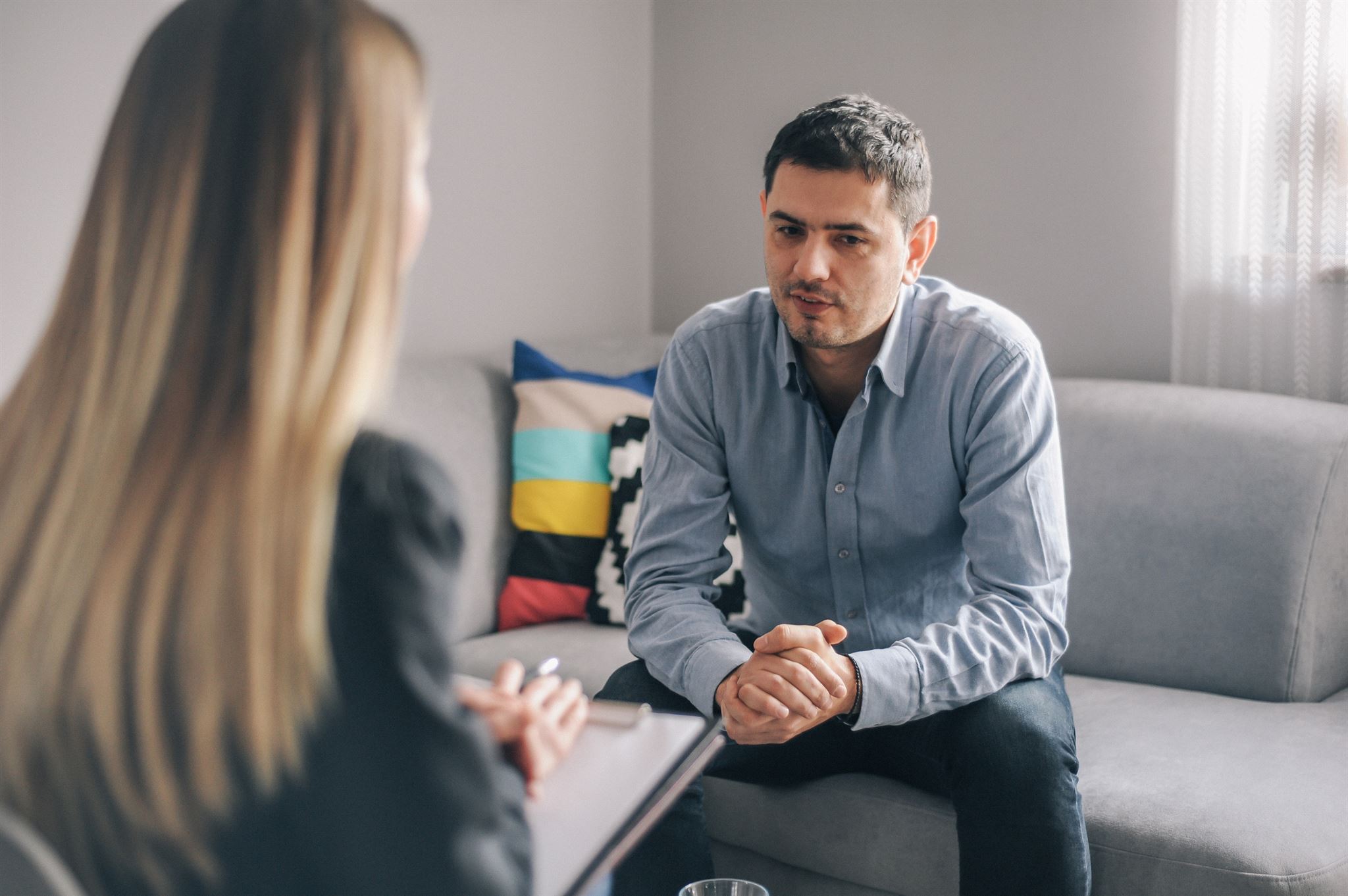 Therapist speaking with patient in comfortable office