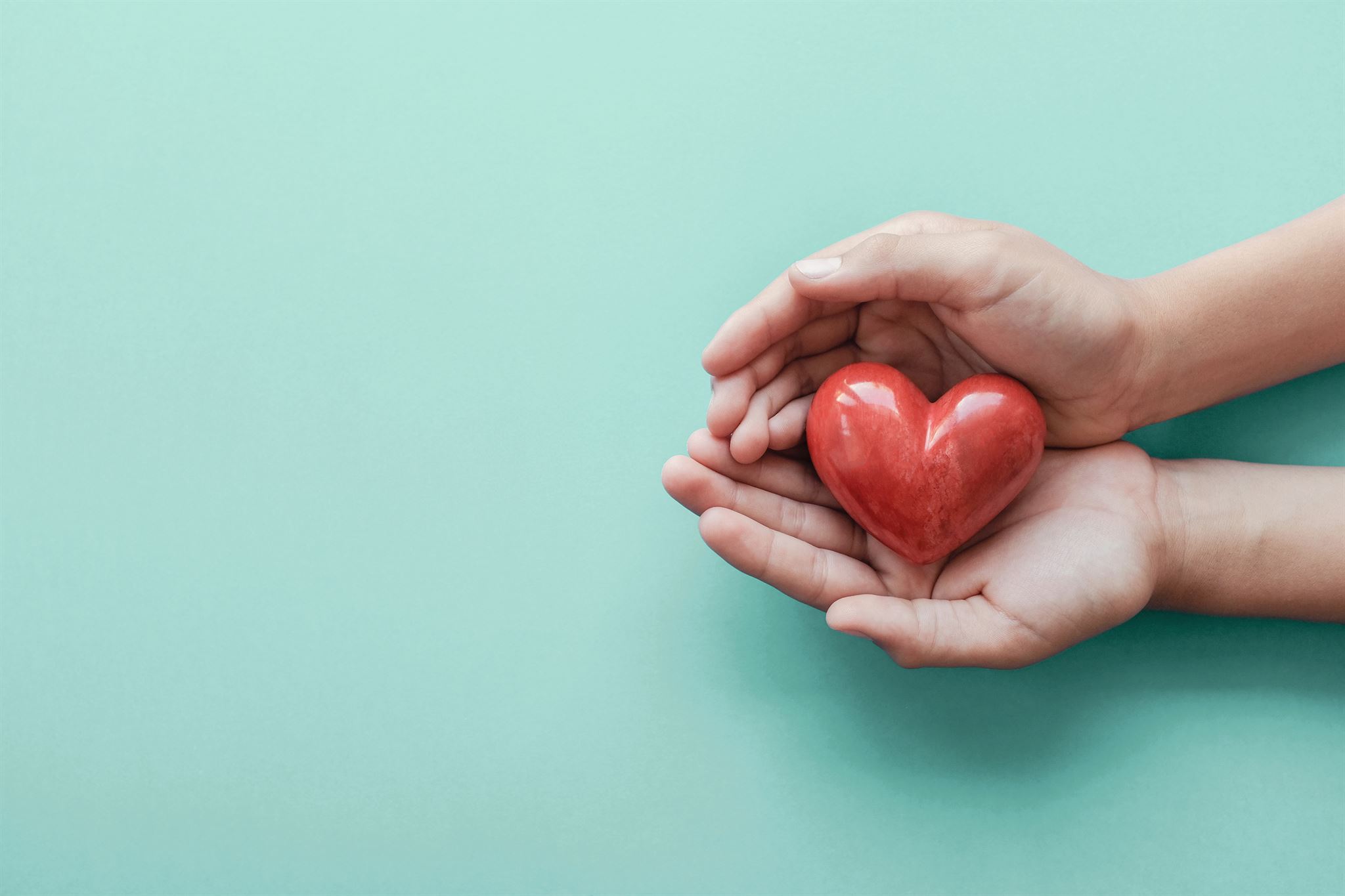 Hands holding heart symbol