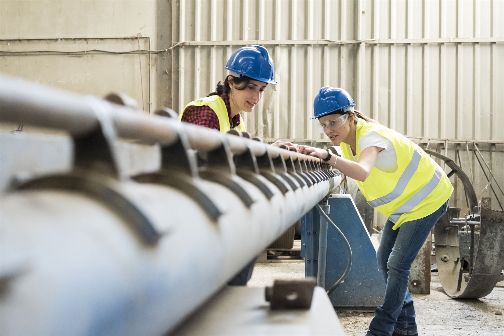 Engineer inspecting metal part